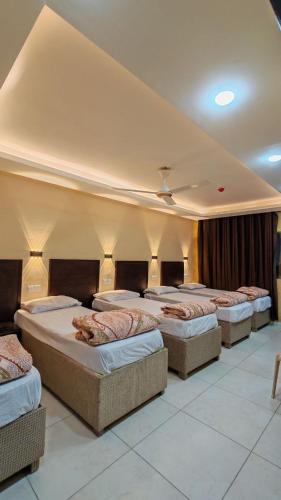 a group of four beds in a room at Aqaba Roza in Aqaba