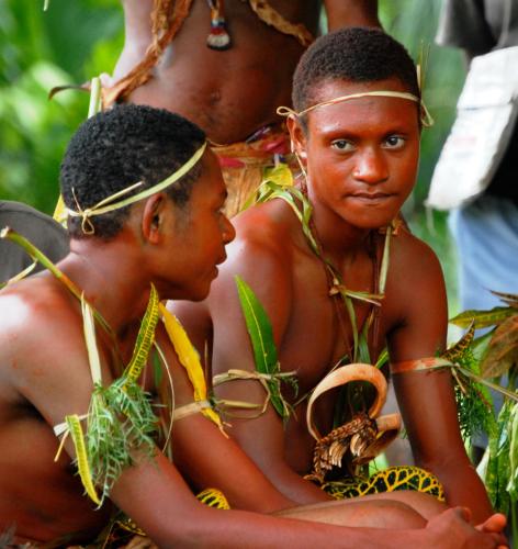 two young children are sitting in a tree at Madang Resort in Madang