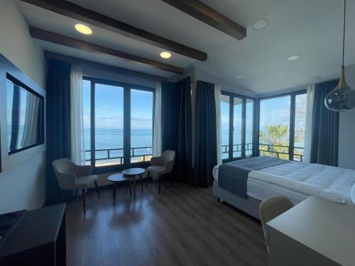 a bedroom with a bed and a table and chairs at Santana Resort Otel in Trabzon