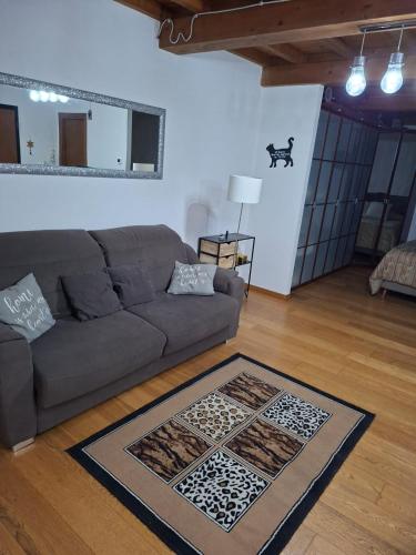 a living room with a couch and a rug at Monolocale di Kris in Borgo a Giovi