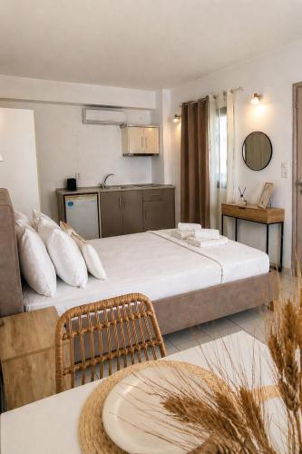 a hotel room with a large bed and a table at Filoxenia in Platy