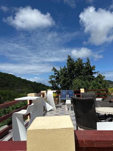 a group of tables and chairs on a roof at Moulin A vent apartment in Monchy