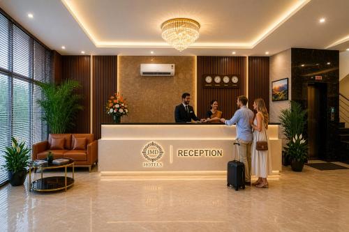 a group of people standing at a reception desk at Hotel Kian by JMD Group in New Delhi
