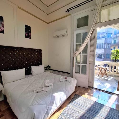 a bedroom with a large bed with towels on it at An ancient pal ace in Cairo