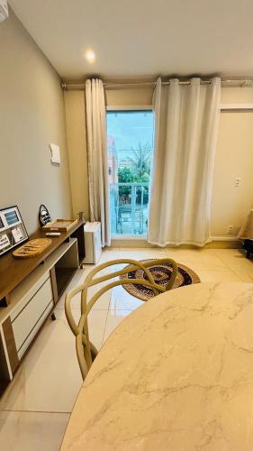 a room with a table and a desk and a window at Blessed House Atins in Atins