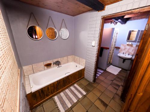 a bathroom with a tub and a sink at Reefteach Lodge in Sodwana Bay