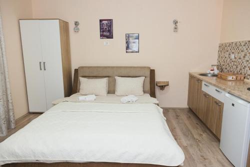 a bedroom with a large bed in a room at Apartments Valentinaa in Gevgelija