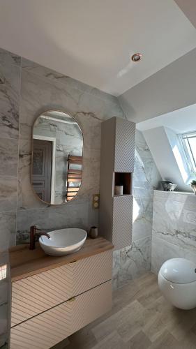 a bathroom with two sinks and a mirror at Studio avec vue piscine in Missy-sur-Aisne