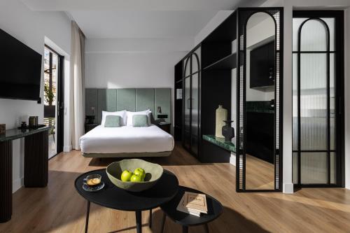 a bedroom with a bed and a bowl of fruit on a table at Zea Urban Living in Piraeus