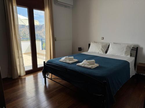 a bedroom with a bed with two towels on it at HillSide Apartments - 02 in Agia Galini