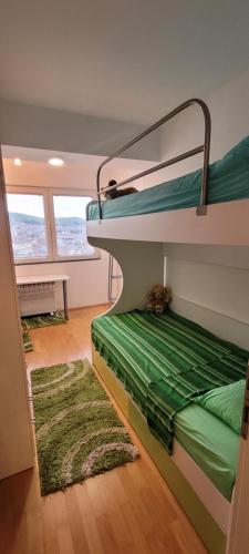a room with two bunk beds and a rug at Lina Apartment in Bitola