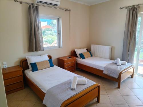 a bedroom with two beds and a window at The View in Souvala