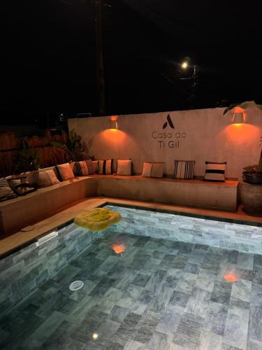 a swimming pool with a couch and a table at Casa Do Ti Gil in Aldeia do Meco