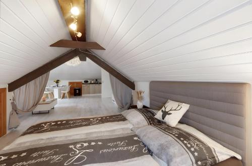 a bedroom with two beds in a attic at Schwarzwaldglück Loft in St. Blasien