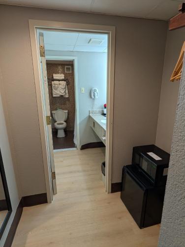 a bathroom with a toilet and a sink at Ramada by Wyndham East Orange in East Orange