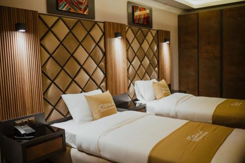 a hotel room with two beds and a telephone at QUALA Hotels in Aksaray
