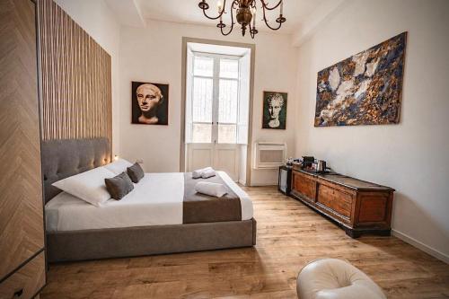 a bedroom with a bed and a table and a window at Sa Costixedda Rooms in Cagliari