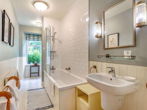 a white bathroom with a sink and a tub at 4 Bed in Huntly oc-88855 in Inverurie