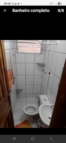 a small bathroom with a toilet and a sink at Suave recanto in Ouro Preto