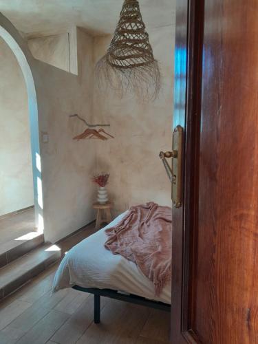 a bedroom with a bed with a painting of a woman at Rosie's Garden in Bocairent