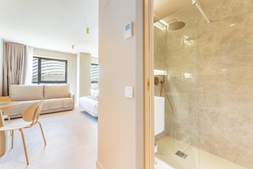 a bathroom with a shower and a bedroom at A2B Collection Arena in Valencia