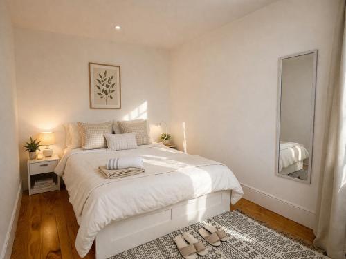 a white bedroom with a bed and a mirror at Cc House Porto in Porto