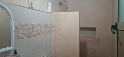 a bathroom with a shower with a glass door at Darna 2 in Demina