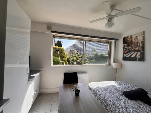 a bedroom with a bed and a window at La Studette Marina 06 in Villeneuve-Loubet