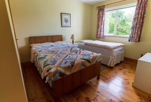 a bedroom with two beds and a window at Lakehouse Waterville in Waterville