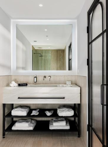 a bathroom with a large sink and a mirror at Zea Urban Living in Piraeus