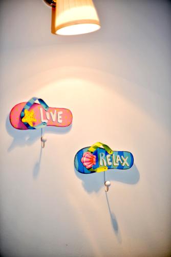 two signs on a wall with a surfboard at Hotel Biscuit in Cluj-Napoca
