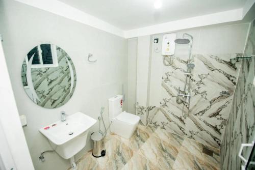 a bathroom with a toilet and a sink and a shower at Wake N Flow, Hiriketiya Beach in Hiriketiya