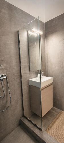 a bathroom with a sink and a shower at Filoxenia in Platy