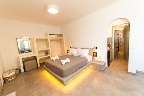 a bedroom with a bed with two towels on it at Agia Marina Caldera suites in Megalochori