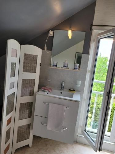 a bathroom with a sink and a mirror at Charmes à Changey in Changey
