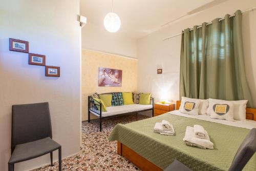 a small room with two beds and a couch at House Klimataria Kamilari in Kamilari