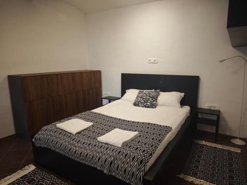 a bedroom with a bed with two towels on it at Apartmaji pr'Muranček in Radovljica