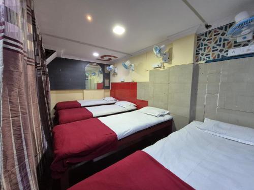 a group of four beds in a room at Swami Single Bed Dormstay in Ratnagiri