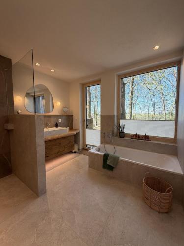 a large bathroom with a large tub and a sink at WaldQuartier in Memmelsdorf