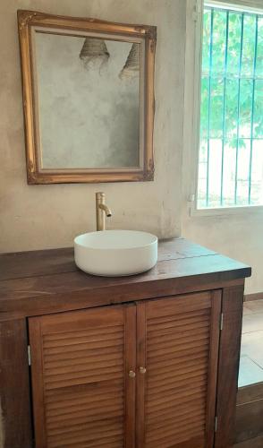 a sink on top of a wooden counter in a bathroom at Rosie's Garden in Bocairent