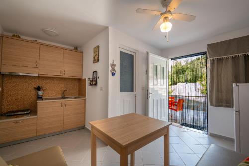 a kitchen with a wooden table and a refrigerator at Vida House in Borsh