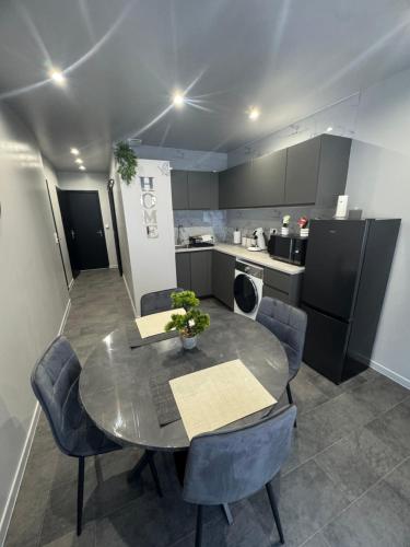 a kitchen with a table and chairs in a room at La nuit nocturne in Bolbec