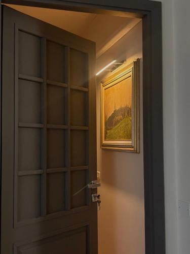 a door in a room with a picture on the wall at Il Sogno di Tebà in Fubine