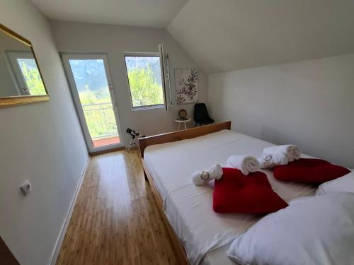 a bedroom with two beds with towels on them at TARA RIVER HOUSE in Odžića Glavica