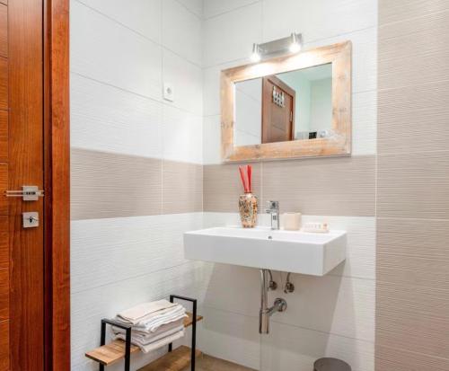 a white bathroom with a sink and a mirror at La Dolce Rustica - Hillside Villa in Sutomore