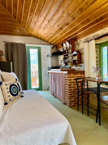 a bedroom with a bed and a table in a room at Atelies View House in Potamiá