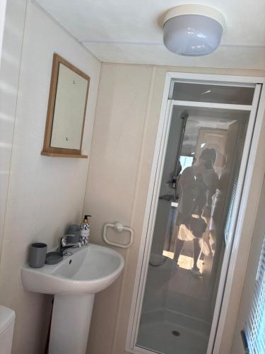 a bathroom with a sink and a shower at S-M Statics in Kinmel Bay