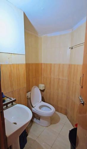 a bathroom with a toilet and a sink at Epindi Studio Apartment in Cox's Bazar