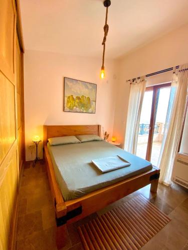 a bedroom with a bed in a room with a window at La Dolce Rustica - Hillside Villa in Sutomore
