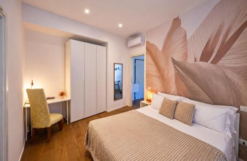 a bedroom with a bed and a desk and a chair at NS Urban Suite in Udine